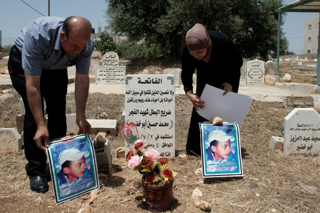 Ayah dan ibu remaja Palestina, Muhammad Abu Khdeir berdoa di makam anak mereka di Shuafat, Timur Baitul Maqdis terjajah, pada Juli 2015. Foto: AFP/Ahmad Gharabli